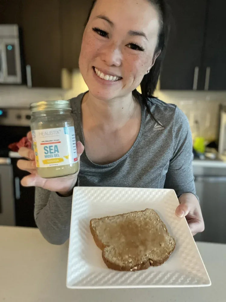 Customer holding sea moss gel alongside breakfast