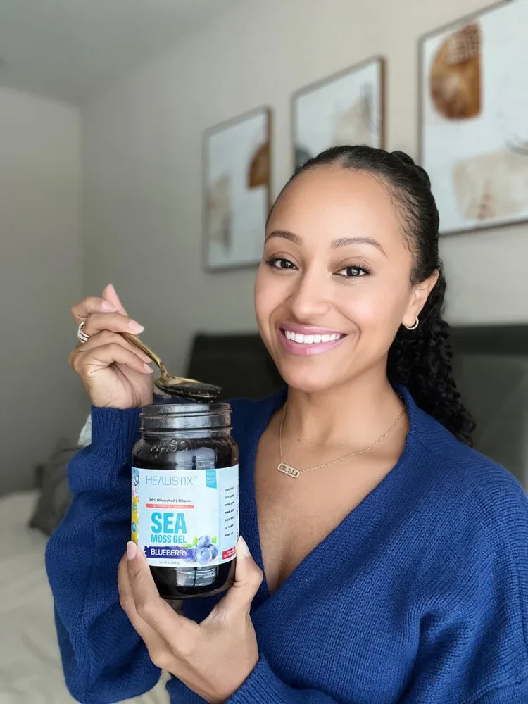 Customer holding Blueberry sea moss gel and a spoon