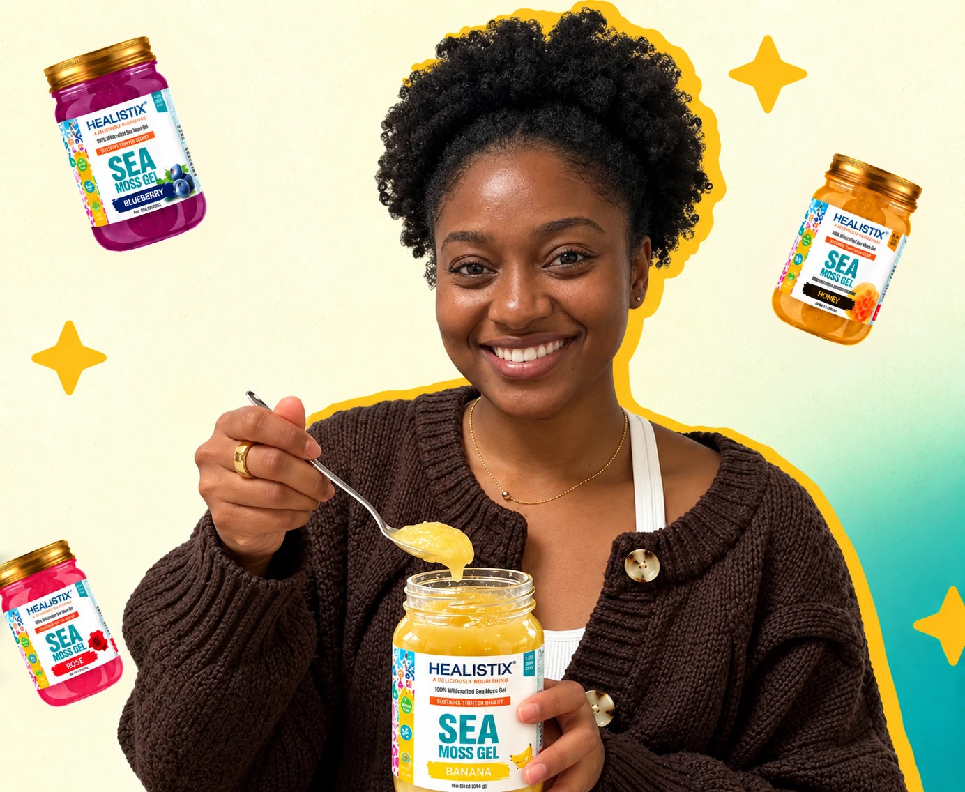 Woman holding Healistix Banana sea moss gel and a spoon, surrounded by Blueberry, Honey and Rose jars
